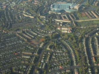 General oblique aerial view of the housing with the engineering works and workshops adjacent, taken from the E.