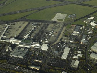 Oblique aerial view of the airport buildings, terminal and apron, taken from the SSE.