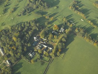 Oblique aerial view of the country house and farmsteading, taken from the SE.