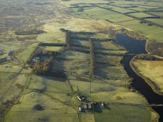 General oblique aerial view centred on the remains of the farmstead, enclosure and rig with the fortified house adjacent, taken from the ENE.