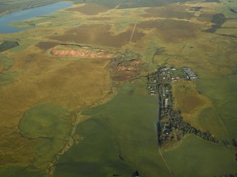 General oblique aerial view centred on the shale-oil works, remains of the shale bings, shale-oil mines, village and remains of the rig, taken from the SSW.