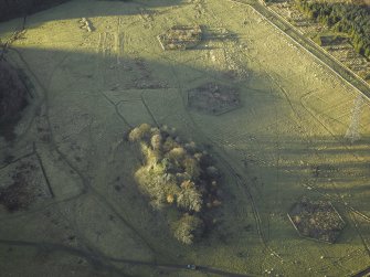 Oblique aerial view centred on the remains of the practice trenches, taken from the SE.