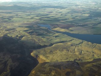 General oblique aerial view centred on the remains of the rig and field systems with the fortified house and reservoir in the distance, taken from the ESE.