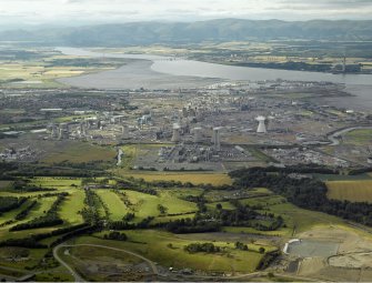 General oblique aerial view centred on the oil refinery with the docks in the distance, taken from the SSE.