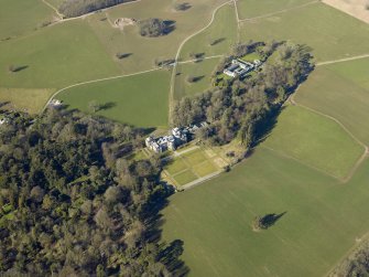 Oblique aerial view centred on the country house, garden and farmsteading, taken from the ESE.