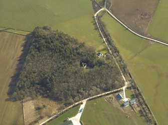 Oblique aerial view centred on the remains of the tower-house, taken from the NW.