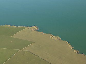 General oblique aerial view centred on the remains of the settlement, promontory forts and observation post, taken from the WSW.
