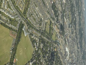 General oblique aerial view of the city centred on the course of the canal and the sports field, taken from the S.