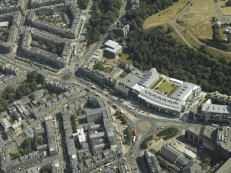 Oblique aerial view centred on the hotel, cinemas and theatre, taken from the W.