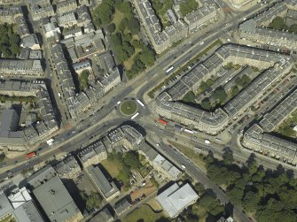 Oblique aerial view centred on the bank and tenements with the school adjacent, taken from the SSE.