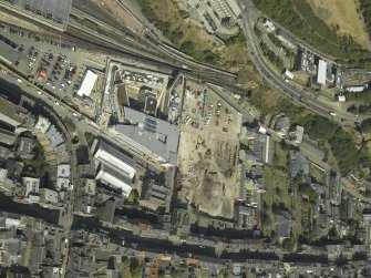 Oblique aerial view centred on the railway goods station and the construction of the car park, taken from the WSW.