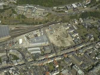 Oblique aerial view centred on the railway goods station and the construction of the car park with the offices adjacent, taken from the S.