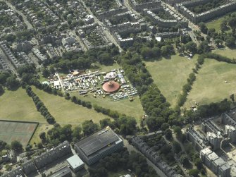 Oblique aerial view centred on the big red tent on The Meadows taken from the NE.
