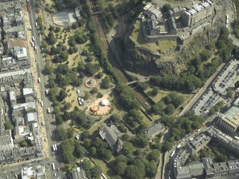 Oblique aerial view centred on the gardens with the castle and church adjacent, taken from the W.