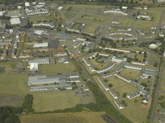 General oblique aerial view centred on the housing estate with the school adjacent, taken from the SSE.