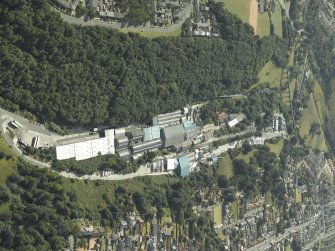 General oblique aerial view of the town centred on the paper mill and house with the railway viaduct in the distance, taken from the NE.