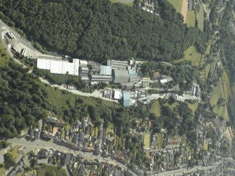 General oblique aerial view of the town centred on the paper mill and house with the railway viaduct in the distance, taken from the NE.