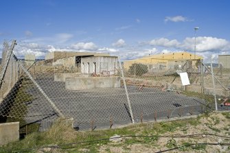 View of fenced compound adjacent to Fabrication Shop.