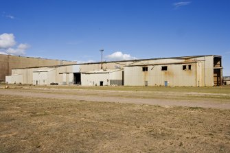 View along SW side of building to SE side of Deck Assembly building (possibly Paint Shop).