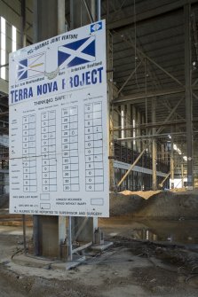 Interior.  Detail of project notice board within Deck Assembly building.