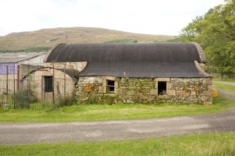 Curved roof building to SE of site, view from S