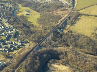Oblique aerial view centred on the railway viaduct and the remains of the rig, taken from the E.
