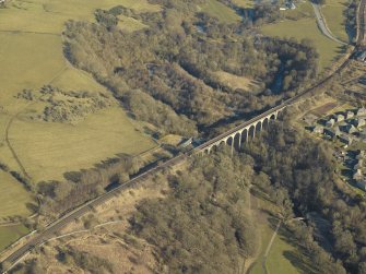 Oblique aerial view centred on the railway viaduct and the remains of the rig, mine and bing, taken from the SW.