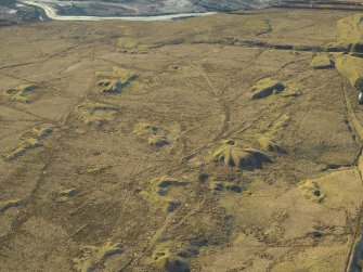 Oblique aerial view centred on the remains of the coal mines and bell pits, taken from the NE.