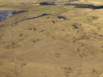 Oblique aerial view centred on the remains of the coal mines and bell pits, taken from the SE.