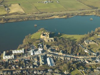 Oblique aerial view centred on the castle, church and burial-ground, taken from the SSE.