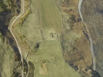 Oblique aerial view centred on the remains of the church and the churchyard, taken from the E.