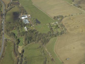 Oblique aerial view centred on the house and the walled garden, taken from the SE.