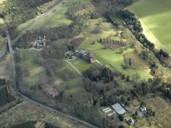 General oblique aerial view centred on the country house, farmsteading, stable and summerhouse, taken from the W.