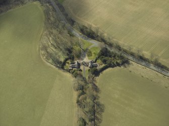 Oblique aerial view centred on the gate-lodges, gate piers and gates, taken from the NE.