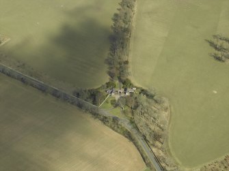 Oblique aerial view centred on the gate-lodges, gate piers and gates, taken from the SW.
