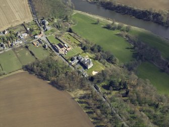 Oblique aerial view centred on the country house, garden and stables, taken from the W.
