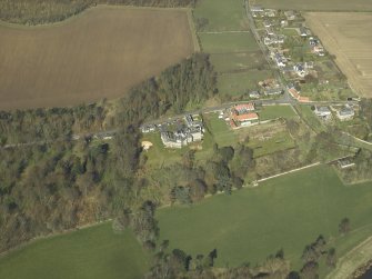 Oblique aerial view centred on the country house, garden and stables, taken from the SE.