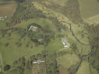 General oblique aerial view centred on the country house, stables and glasshouse, taken from the S.