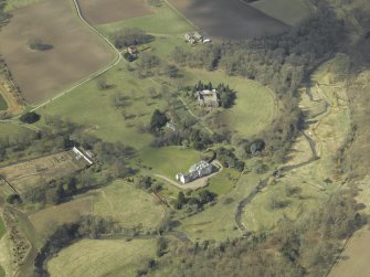 General oblique aerial view centred on the country house, stables, glasshouse and walled garden, taken from the E.