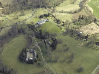 General oblique aerial view centred on the country house, stables, glasshouse and walled garden, taken from the W.