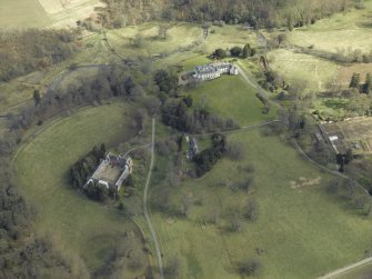 General oblique aerial view centred on the country house, stables and glasshouse, taken from the WSW.