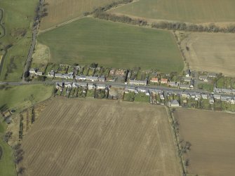 General oblique view of the village, centred on the church, school, schoolhouse and war memorial, taken from the SE.