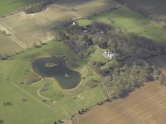 Oblique aerial view centred on the country house with the walled garden, cottages, barn and stable adjacent, taken from the ENE.