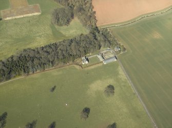 Oblique aerial view centred on the dovecot, kennel and cottage, taken from the SSE.