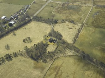 Oblique aerial view centred on the country house with the farmsteading adjacent, taken from the NE.