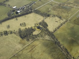 Oblique aerial view centred on the country house with the farmsteading adjacent, taken from the NNE.