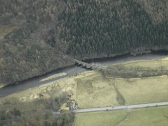 Oblique aerial view centred on the railway viaduct with the cottage adjacent, taken from the NW.