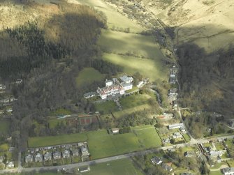 Oblique aerial view centred on the hotel and gate-lodge, taken from the SSW.