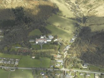 Oblique aerial view centred on the hotel and gate-lodge, taken from the S.