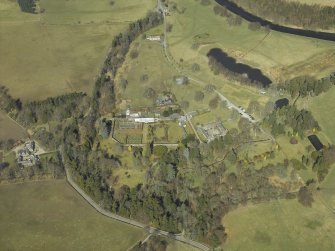 Oblique aerial view centred on the country house, gardens, walled garden and stables with the dovecot adjacent, taken from the SSE.